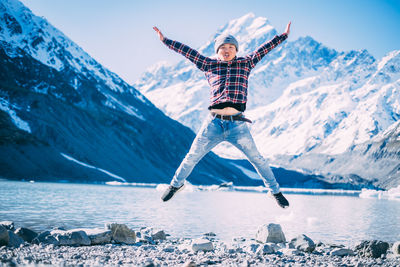 Man jumping on snowcapped mountain