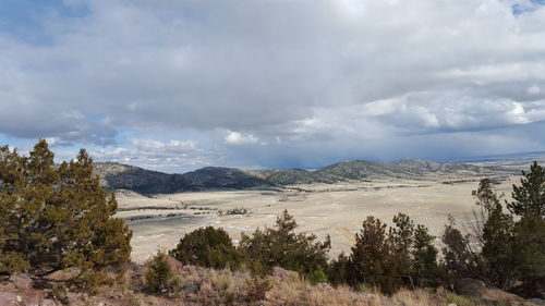 Scenic view of mountains against cloudy sky