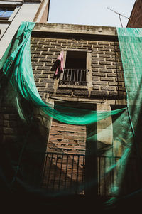 Low angle view of clothes drying against building