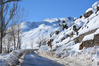 Scenic view of snow covered mountains against clear sky