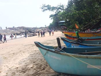 People on beach against clear sky