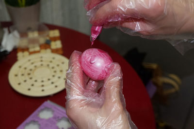 Hands of person painting easter egg