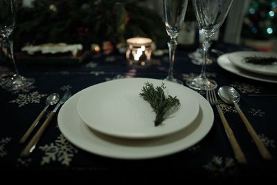 Close-up of plates and glasses on table