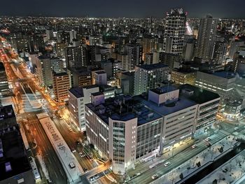 High angle view of illuminated buildings in city at night