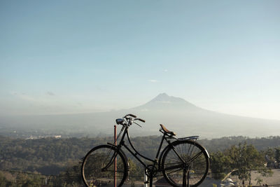 Bicycle on mountain against sky