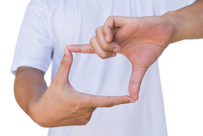 Close-up of hands over white background