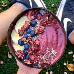 High angle view of hand holding strawberry