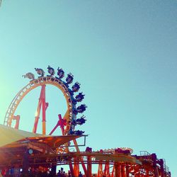 Low angle view of ferris wheel against clear sky