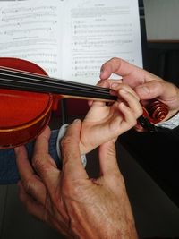 Close-up of man playing guitar