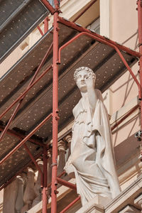 Low angle view of statue against building