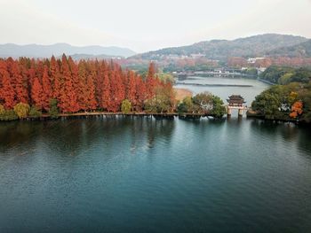 Scenic view of river by trees against sky during autumn