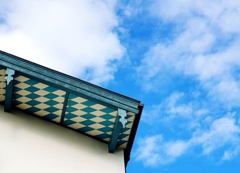 Low angle view of sign against blue sky