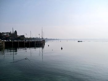 Sailboats in sea against sky