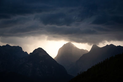 Scenic view of silhouette mountains against sky during sunset