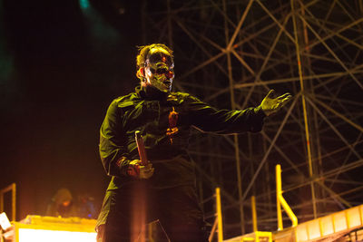 Low angle view of illuminated man at night