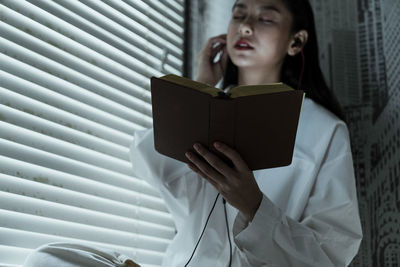 Mid adult woman reading book