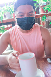 Midsection of coffee cup on table