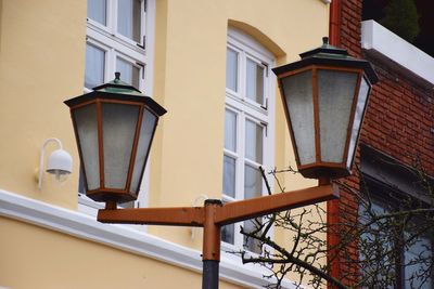 Low angle view of street light against building