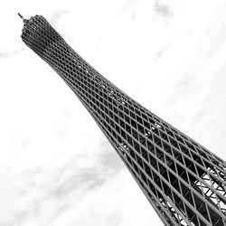 Low angle view of skyscraper against cloudy sky