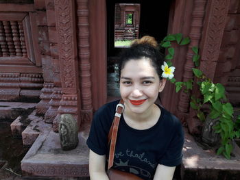 Portrait of smiling young woman standing outdoors