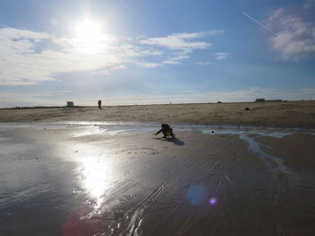 Silhouette person on beach against sky