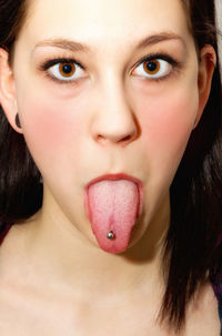 Close-up of woman with piercing on tongue