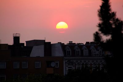Buildings in city at sunset