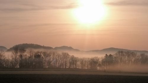 Scenic view of landscape against sky during sunset