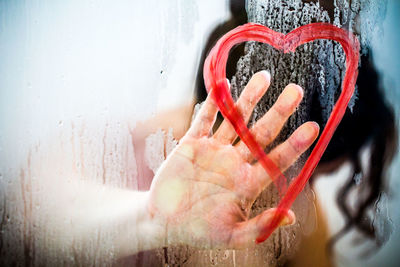 Close-up of heart shape on glass