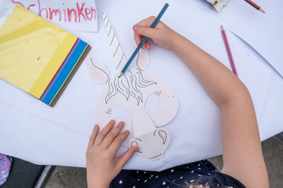 High angle view of human hand holding paper