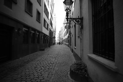 Narrow street amidst buildings in city