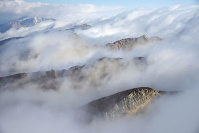 Smoke emitting from volcanic mountain against sky