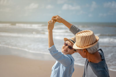 Senior couple dancing at beach