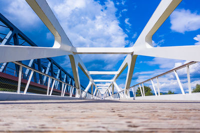 Low angle view of footbridge against sky