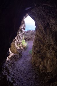 Scenic view of sea seen through cave