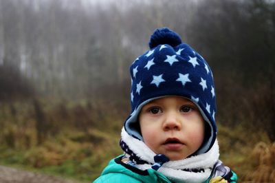 Close-up of cute boy looking away while wearing knit hat