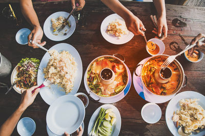 High angle view of people having food at dining table