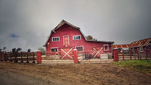 Exterior of house by building against sky