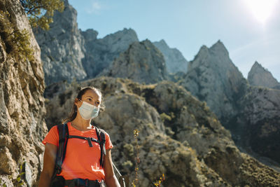 Man standing on rock against mountains