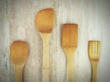 Directly above shot of various wooden spatulas on table