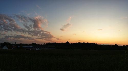 Scenic view of silhouette field against sky during sunset