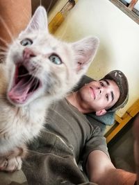 Portrait of woman with cat at home