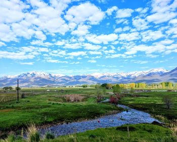Scenic view of field and mountains against sky