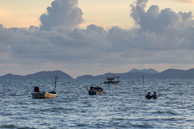 People on sea against sky