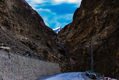 Road amidst mountains against sky