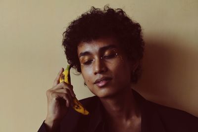 Portrait of young man against wall