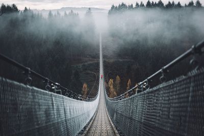 Geierlay hangeseilbrucke over valley during foggy weather