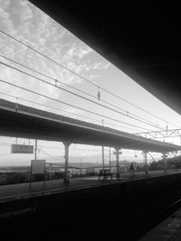 Railway bridge against cloudy sky