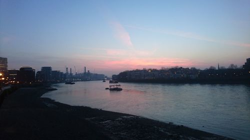 Scenic view of illuminated city against sky at sunset