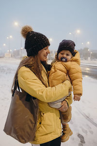 Young couple standing in snow during winter